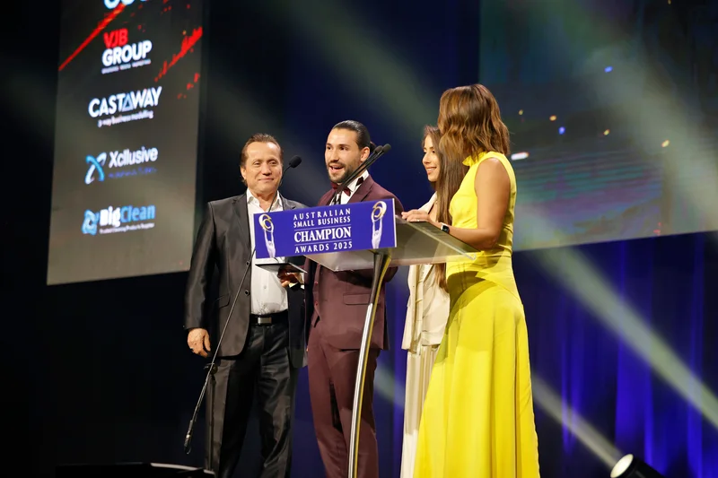 Emre speaking at podium